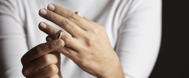 Woman taking off her marriage ring