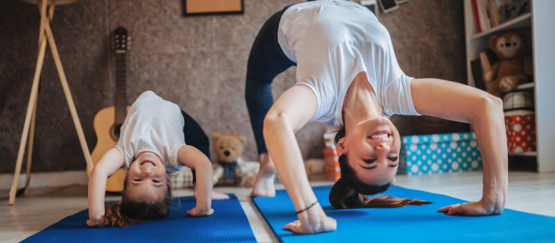 mother and daughter doing a backbend