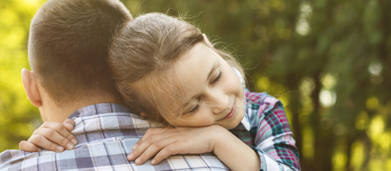 daughter holding on to father