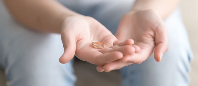 someone holding a wedding band in their hands