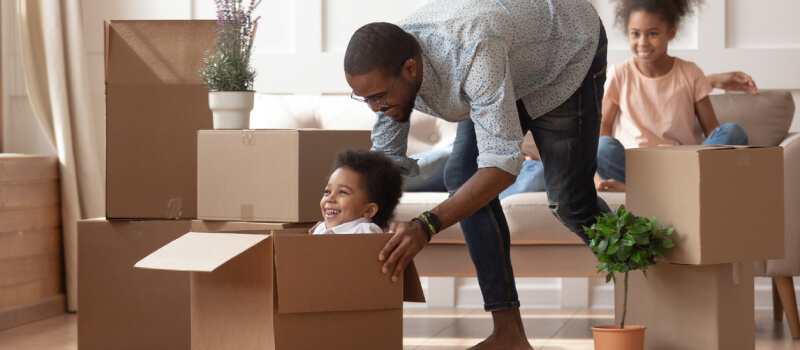 Father playing with son in a moving box