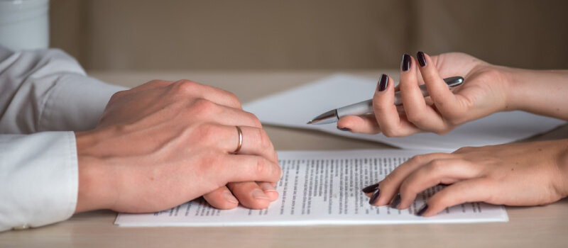 Man and woman signing papers