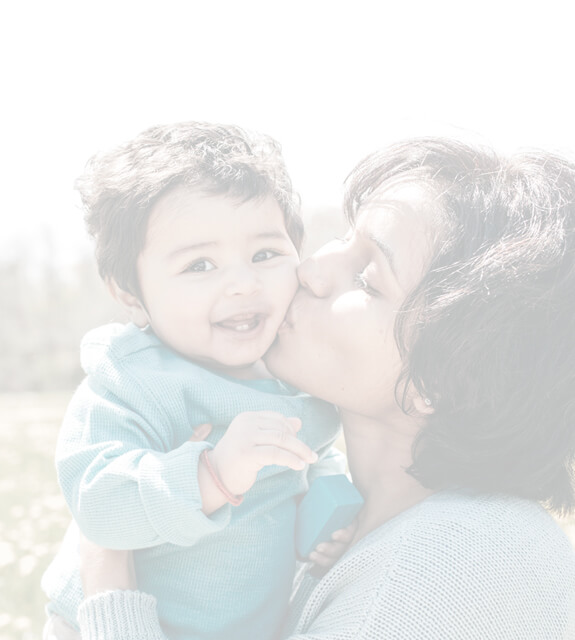 Mom kisses toddler's cheek