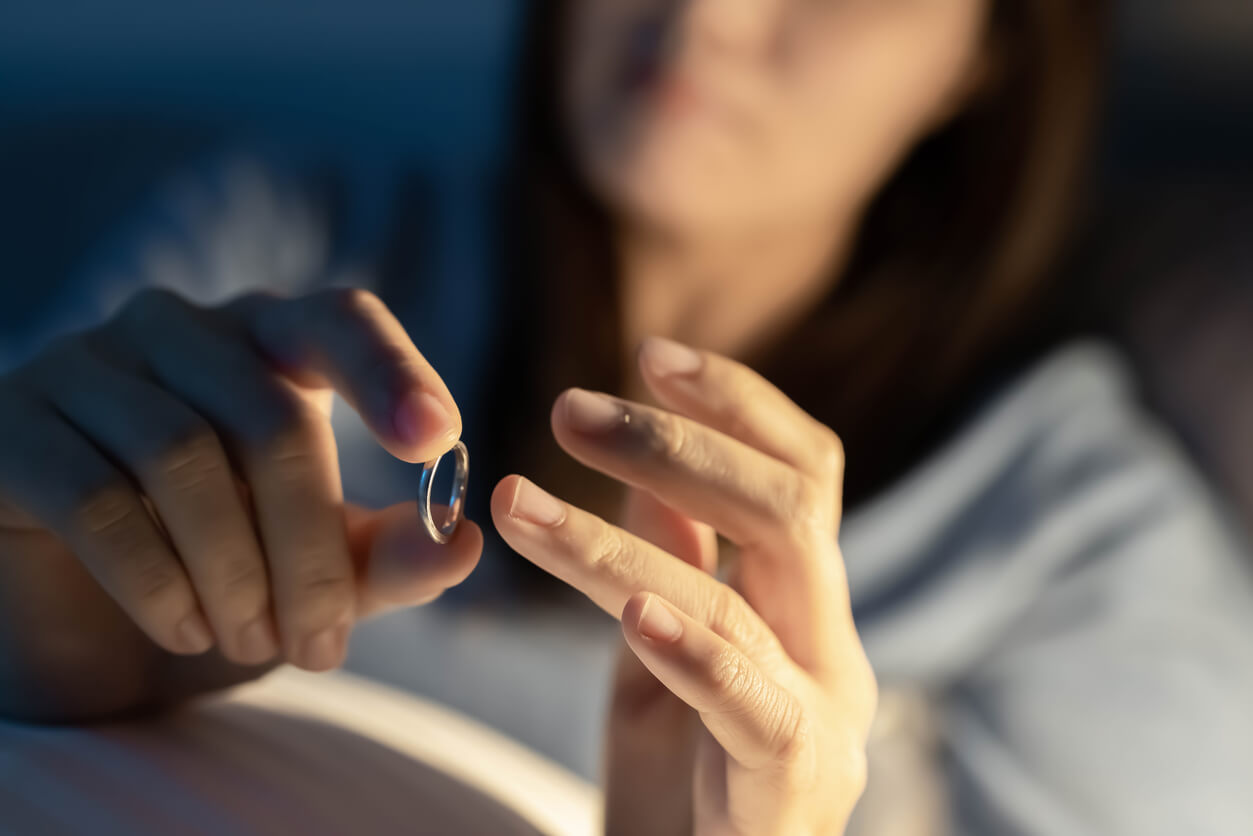 woman taking off her wedding ring