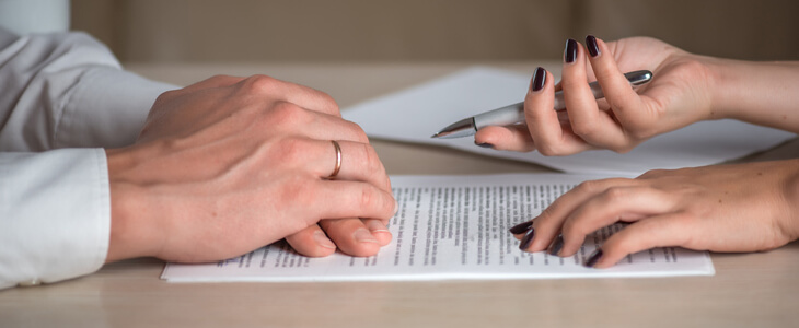 man and woman signing a contract
