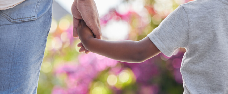 Young mother holding the hand of her son