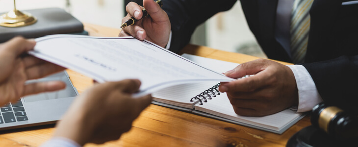 Lawyer showing divorce papers to a male client