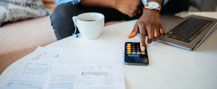 Young man performing tax calculations on his table after a divorce