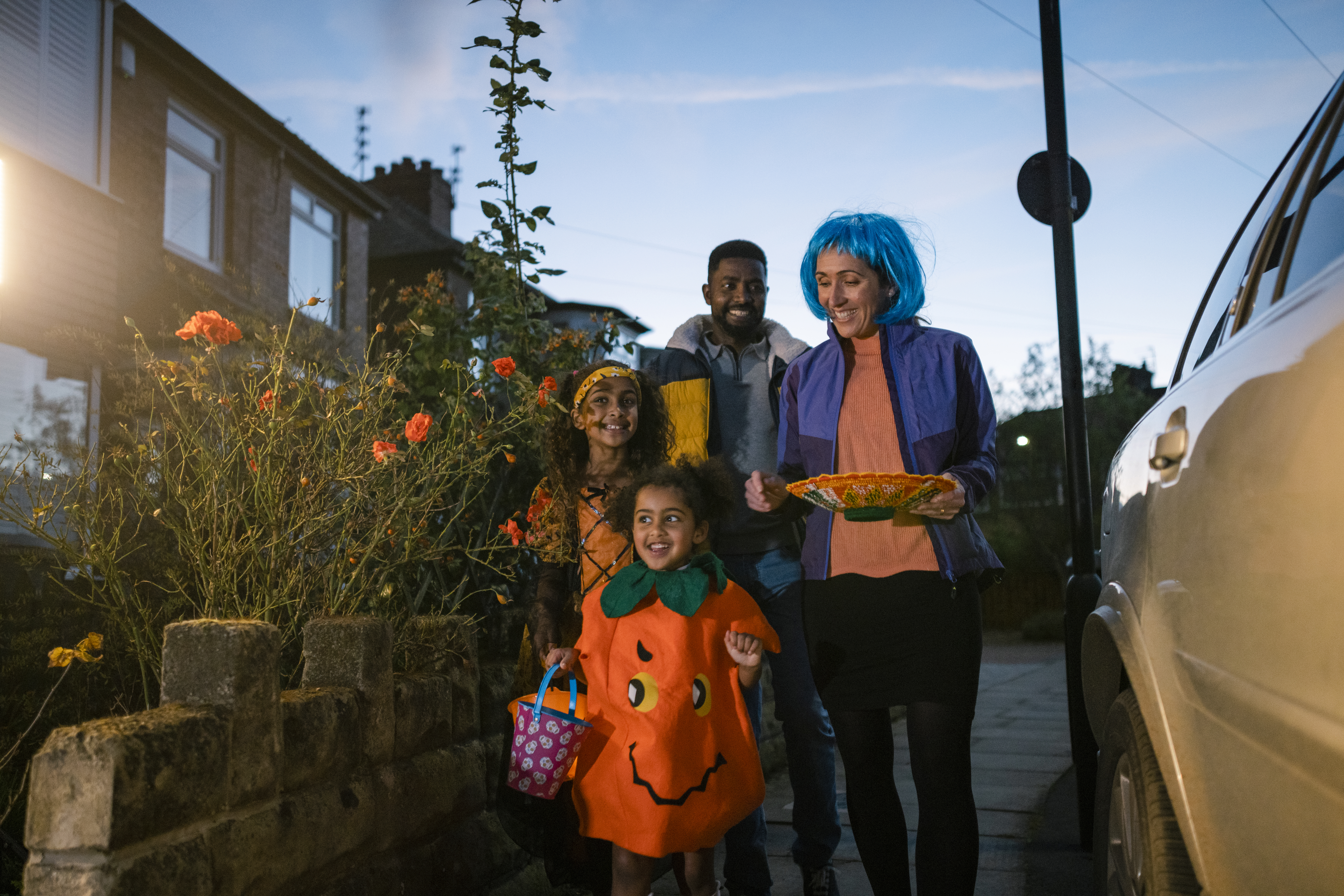 parents trick or treating with child