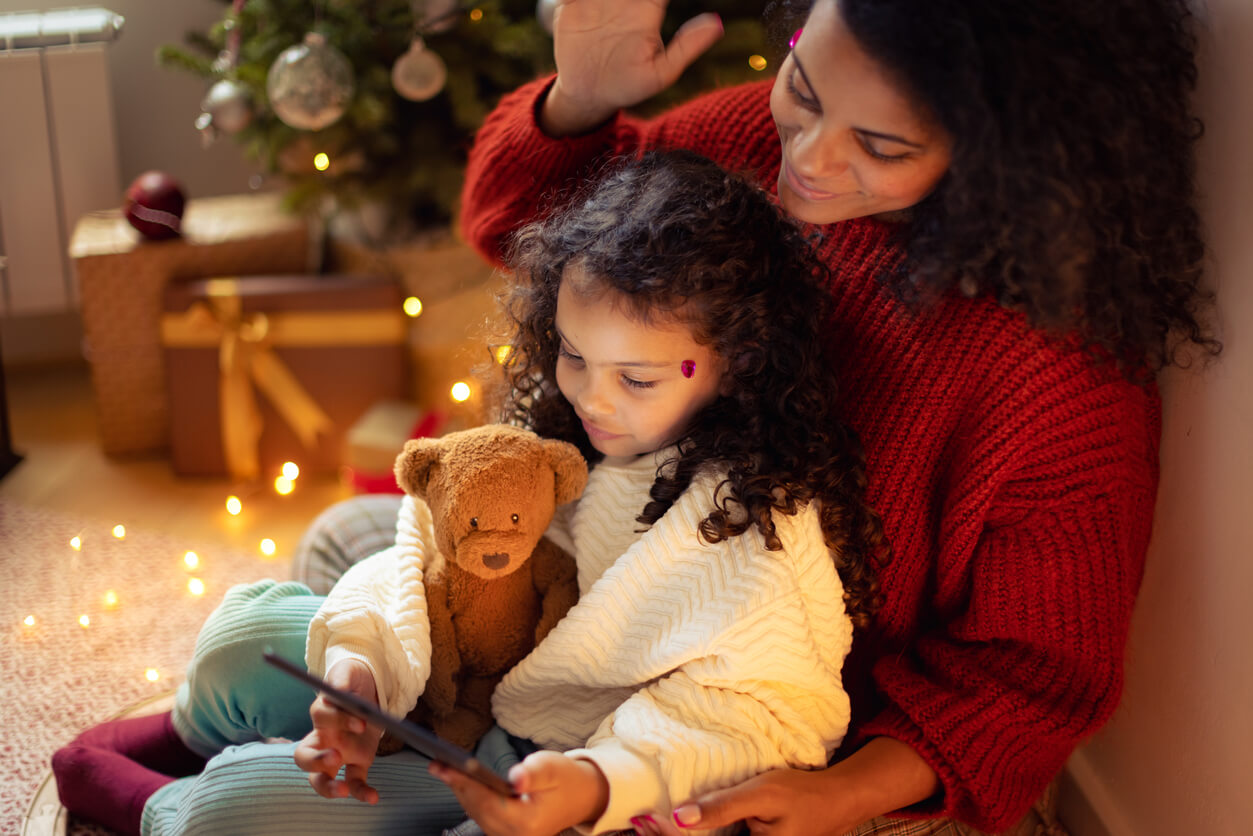 woman and child by christmas tree