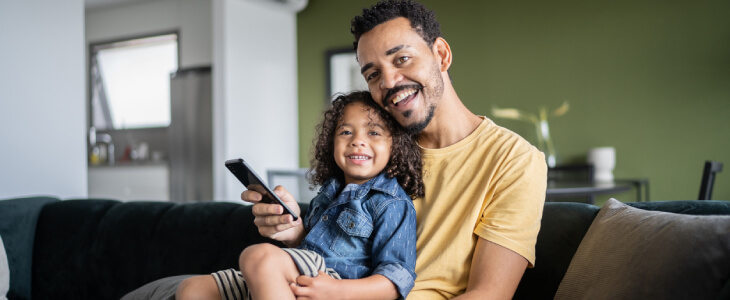 Father with child sitting on lap.