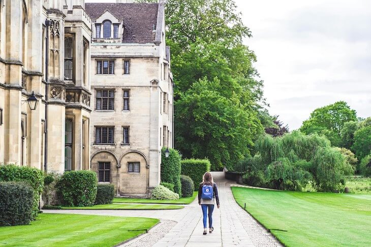 young student walks on college campus