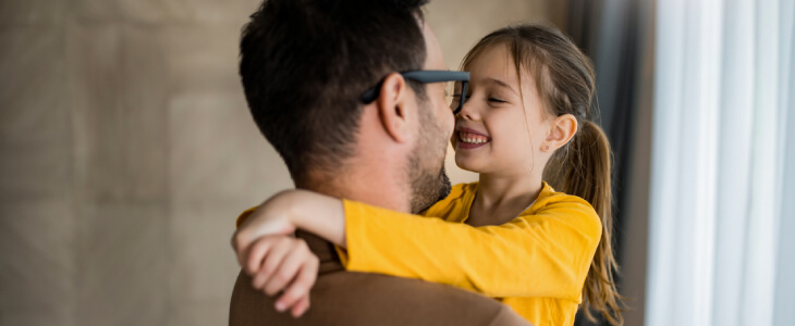 Young girl hugging father