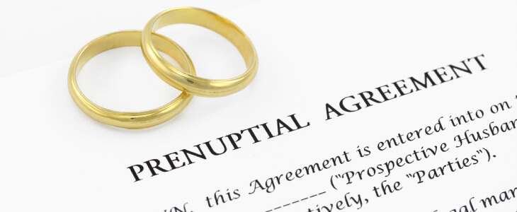 Prenuptial agreement paper and wedding bands