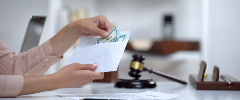 Woman holding an envelope with cash inside