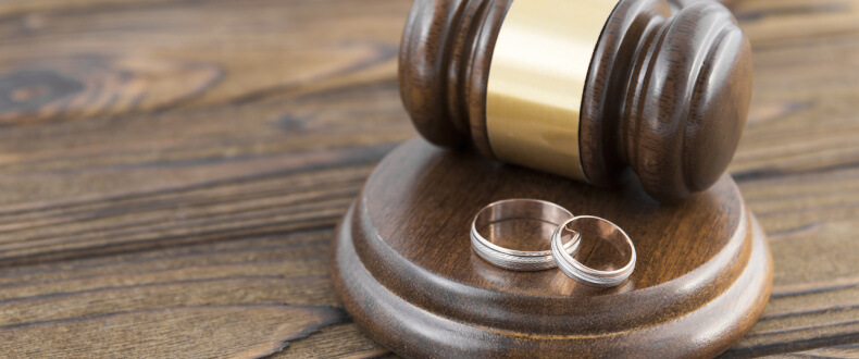 Wedding rings on a legal gavel.