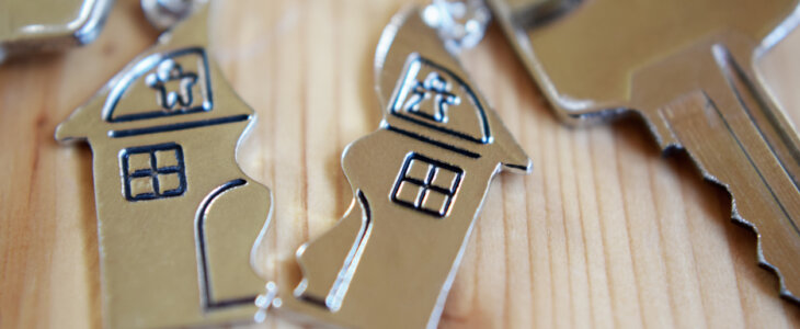 Splitted or broken pendant of key ring in shape of house
